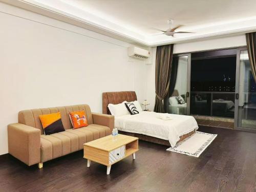 a living room with a bed and a couch at TheBess Hotel Tokyo is located adjacent to Singapore and offers a sea viewIt is a family business smart room with the sea view of Princess Bay富力公主湾 in Johor Bahru