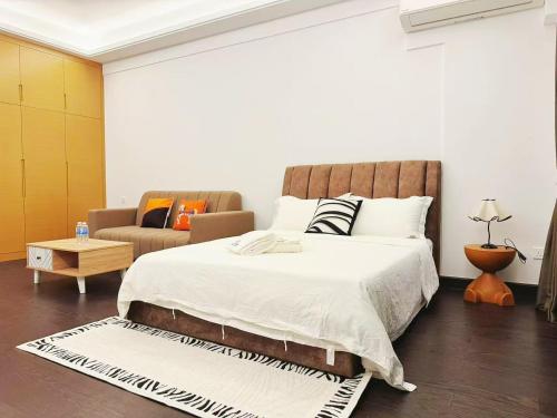 a bedroom with a large bed and a couch at TheBess Hotel Tokyo is located adjacent to Singapore and offers a sea viewIt is a family business smart room with the sea view of Princess Bay富力公主湾 in Johor Bahru
