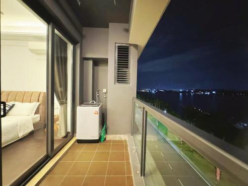 a room with a balcony with a view of the ocean at TheBess Hotel Tokyo is located adjacent to Singapore and offers a sea viewIt is a family business smart room with the sea view of Princess Bay富力公主湾 in Johor Bahru