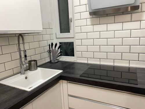 a kitchen with a sink and white subway tiles at Casa Salima a Deiva Marina tra 5 Terre e Portofino in Deiva Marina