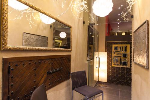 a mirror and a chair in a room at La Grotta Hotel in San Marino