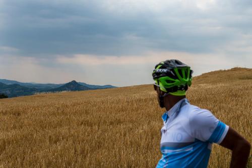 a man wearing a helmet standing in a field at La Grotta Hotel in San Marino