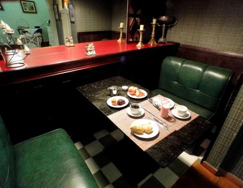 a table with plates of food on it in a restaurant at Pousada Estalagem de Brotas in Brotas