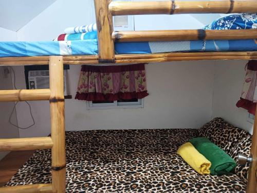 a room with two bunk beds with a leopard carpet at Aremen Transient, the no hassle and no fuss BR with shared bathroom in San Juan