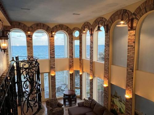 a living room with a view of the ocean at 1st to the Beach-Sunset Beach-Beachfront-Pet Friendly-Hot Tub in St. George Island