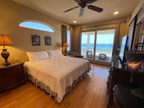 a bedroom with a bed with a view of the ocean at 1st to the Beach-Sunset Beach-Beachfront-Pet Friendly-Hot Tub in St. George Island