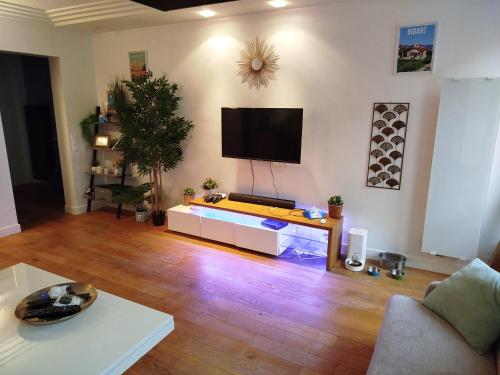 a living room with a flat screen tv on the wall at Chambre chez l'habitant à Paris centre in Paris