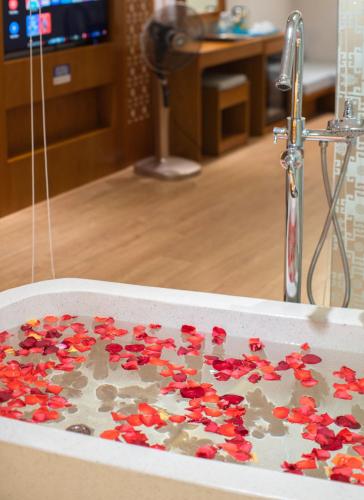 a bath tub filled with red rose petals at Le's Cham Hotel in Nha Trang