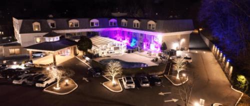 an aerial view of a building with a parking lot at Norwalk Inn & Conference Center in Norwalk