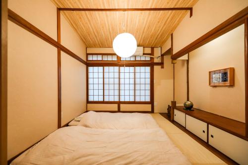 a bedroom with a large bed and a window at 5 minutes on foot from tokyo Asakusa Station!A beautiful house that has been fully renovated in 2024 for one group per day東京雷門から徒歩4分1日1組限定貸切2024年全面リフォーム済みの綺麗な一軒家 in Tokyo