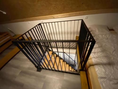 an overhead view of a metal staircase next to a bed at Baracek, Baraque in Horčápsko
