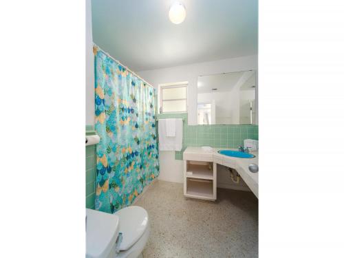 a bathroom with a sink and a toilet and a mirror at Sugarloaf Serenity in Sugarloaf Shores
