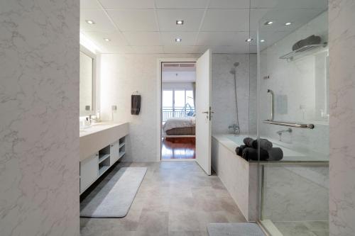 a bathroom with a tub and a sink and a shower at FULL SEA VIEW Burj AlArab and Burj Khalifa, Private Beach, 5 Stars Resort The Palm Jumeirah in Dubai