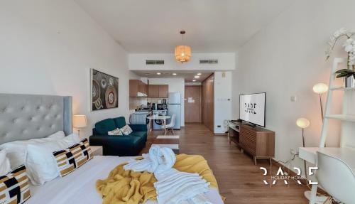 a living room with a bed and a couch at Rare Holiday Homes - Lake View - The Lago Vista Tower A - Dubai Production City - R1503 in Dubai