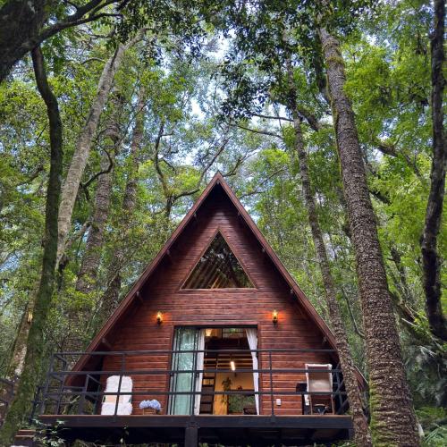 a small cabin in the woods with trees at Cabana na Serra Rs in São Francisco de Paula