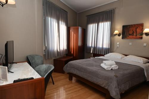 Postel nebo postele na pokoji v ubytování Hotel Achillion