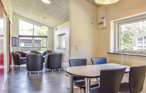 a waiting room with a table and chairs at Holiday Home Halvejen Hytte Spjald Xii in Spjald