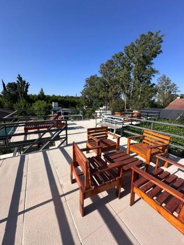 a group of wooden benches sitting on a sidewalk at La posta del vasco in Tanti
