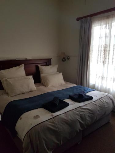 Ένα ή περισσότερα κρεβάτια σε δωμάτιο στο Lilac Lodge