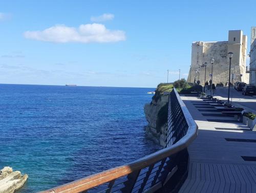 a view of the ocean from a walkway next to the ocean at Side Sea View D, Steps Away to Bugibba Jetty, For the Blue Lagoon Boats and Other Islands in St Paul's Bay