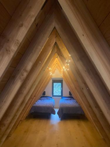 a room with two beds in a attic at A-huis in het bos van Drenthe in Norg