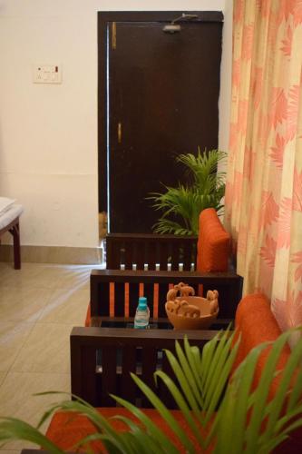 a living room with a couch and a television at Sudhaksha Celebrations in Prayagraj