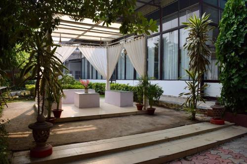 a pavilion with trees and plants in a building at Sudhaksha Celebrations in Prayagraj