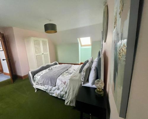 a bedroom with a bed with a green floor at Rhianfa 4 bedroom house minutes walk from the beach in New Quay