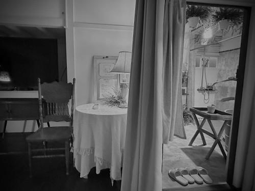 a room with a table with a lamp and a table with shoes at HomeOne36 后灣灣inn - 勝利星村日式老屋包棟 - in Pingtung City