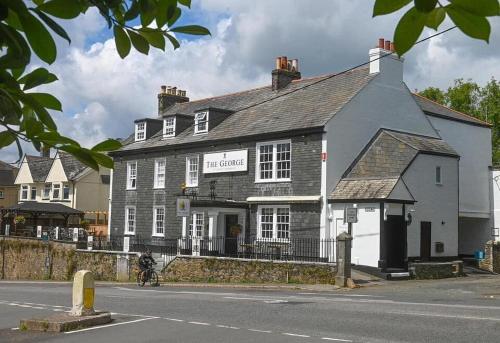 a black and white building on the corner of a street at The George Inn Plympton in Plymouth