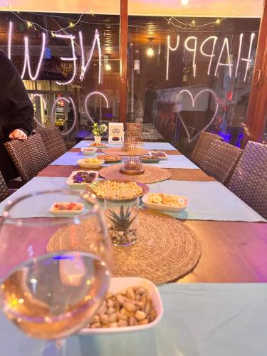 a long table with plates of food and glasses of wine at Agora Boutique Apart Hotel in Alanya