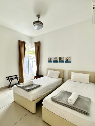 a bedroom with two beds and a window at Lux Villa 6rm 12 to 22 pax Wifi Netflix BBQ SteamBoat Games Beach Water Park in Desaru