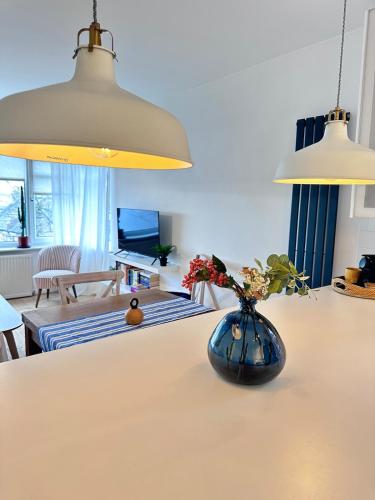 a vase with flowers on a table in a living room at No9 Estuary Views in Southend-on-Sea