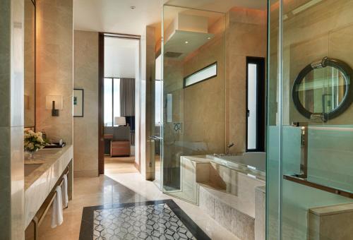 a bathroom with a tub and a sink and a mirror at Phuket V Building 19 Villas with Andaman Sea View Private Swimming Pool and Spa in Ban Ao Makham