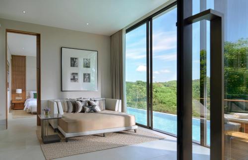 a bedroom with a couch and a bed and a pool at Phuket V Building 19 Villas with Andaman Sea View Private Swimming Pool and Spa in Ban Ao Makham