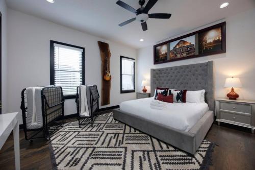a bedroom with a bed and a ceiling fan at Two Townhomes- Rooftop Lounge- Hot Tub- City Views in Nashville
