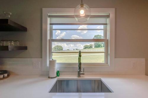 a sink in a kitchen with a window at Ultra Relaxing and Fun Historic Franklin Bungalow in Franklin