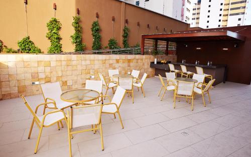 a group of tables and chairs on a patio at Comfort Hotel & Suites Natal in Natal