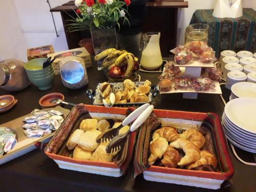 a table with several trays of food on it at Casa Grande Hotel Tilcara in Tilcara