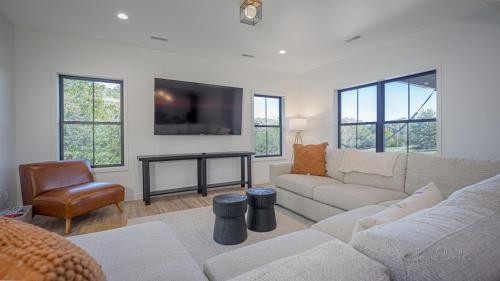 a living room with a couch and a tv at Shenandoah Ridge Fall Escape - Hot Tub - Fire Pit - Scenic Galena Views in Galena