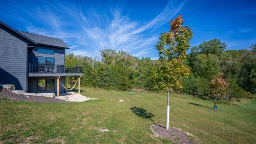 a house with a tree in the yard at Shenandoah Ridge Fall Escape - Hot Tub - Fire Pit - Scenic Galena Views in Galena