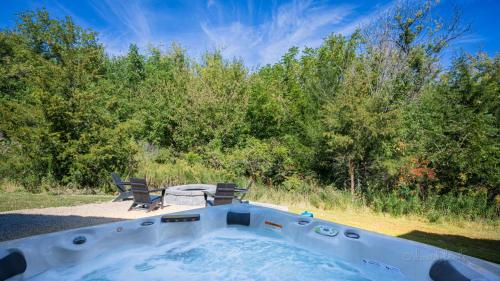 a hot tub with two chairs and a table at Shenandoah Ridge Fall Escape - Hot Tub - Fire Pit - Scenic Galena Views in Galena