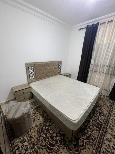 ein Schlafzimmer mit einem Bett und einem Stuhl in der Unterkunft Ara Home in Amman