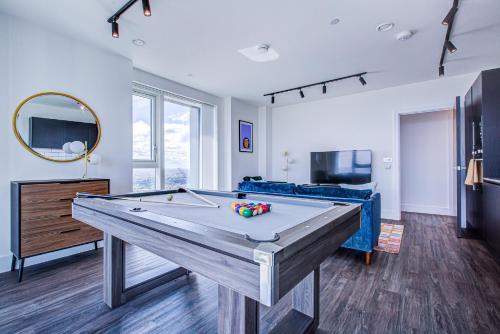 a living room with a pool table in it at Legacy Punks by Artsy in London