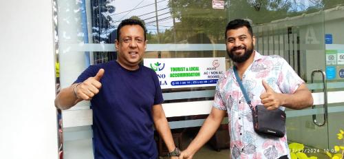 two men giving thumbs up in front of a building at Vino Villa Tourists & Local Accommodations - 24 Hrs in Kandy