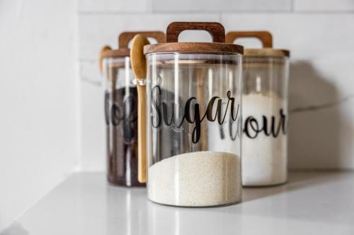 a group of three containers filled with spices at Mid-Century Modern Retreat in Little Italy in Cleveland