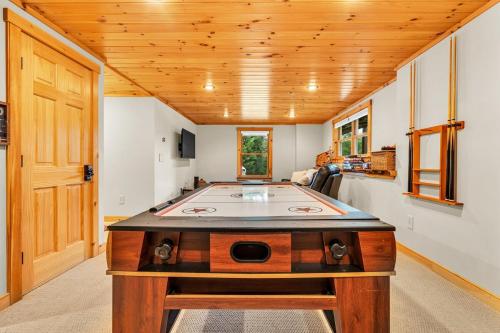 a pool table in the middle of a room at Private Chalet with Fireplace Hottub and Game Room in Bethel