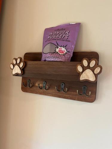 a wooden shelf on a wall with a book and footprints at Private Chalet with Fireplace Hottub and Game Room in Bethel