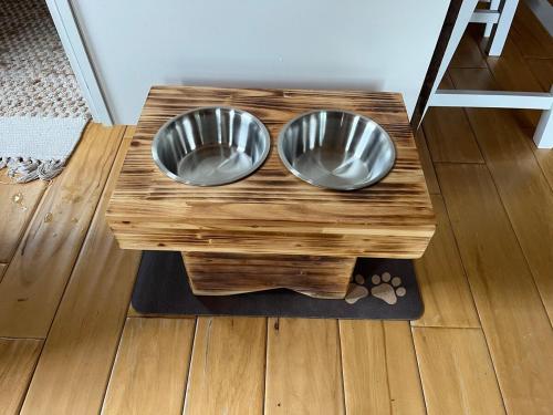 two metal bowls sitting on a wooden table at Private Chalet with Fireplace Hottub and Game Room in Bethel