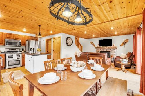 a kitchen and living room with a table and chairs at Private Chalet with Fireplace Hottub and Game Room in Bethel